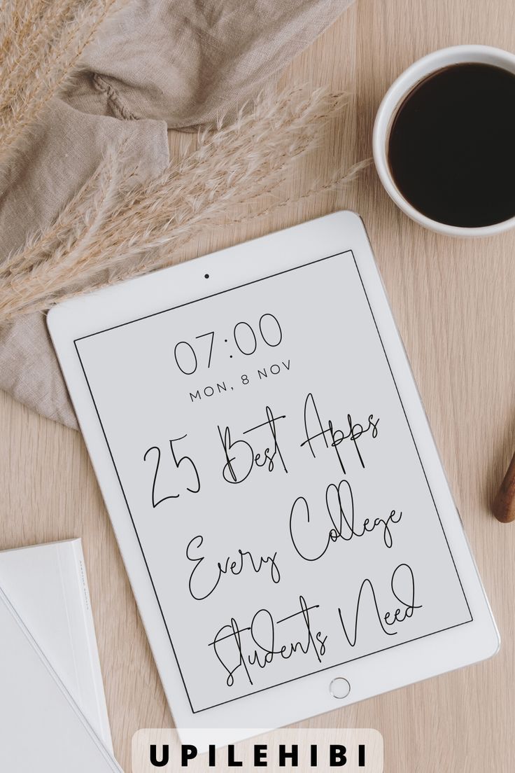 a tablet with writing on the screen next to a cup of coffee and an envelope