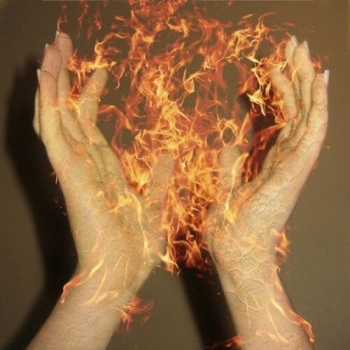 two hands are shown with fire in the middle and on top of them, both holding their hands together