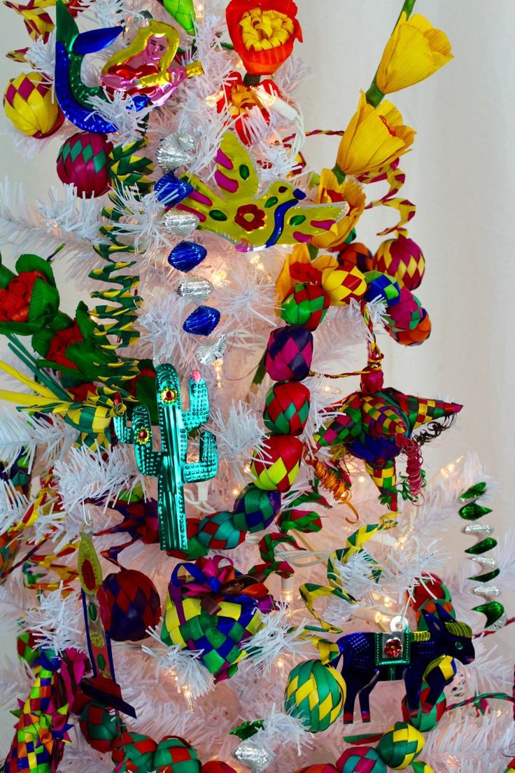 a white christmas tree decorated with colorful ornaments