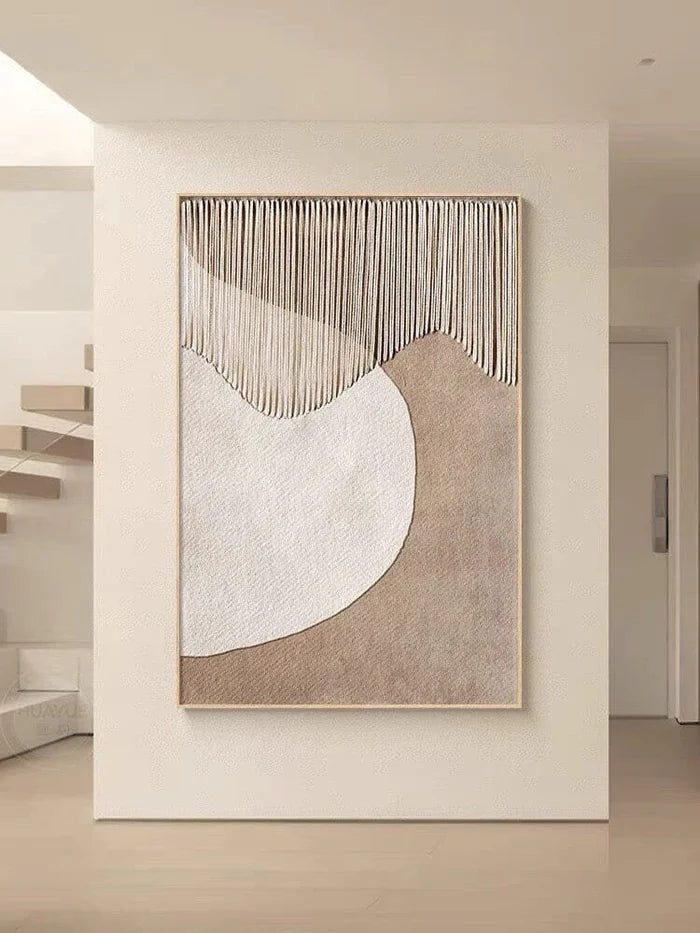 an abstract painting hanging on the wall in a living room with stairs and white walls