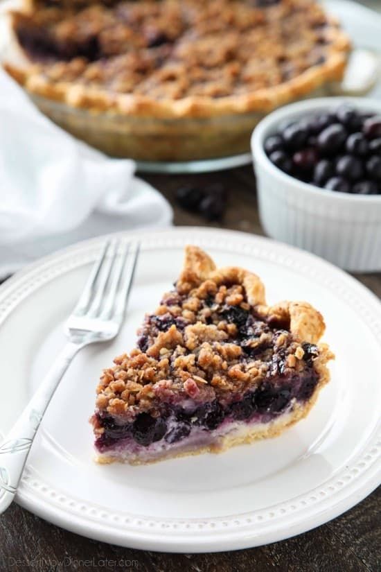 a slice of blueberry pie on a white plate