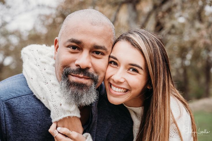 a man and woman smile at the camera