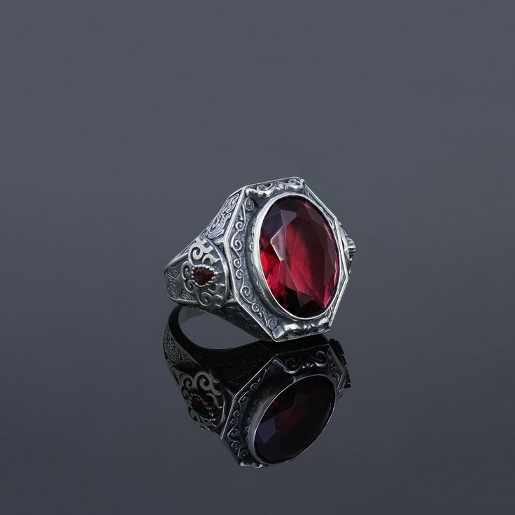 Bold and masculine lines were used in the design with carvings and geometric shapes. Inspired by the Art Deco movement, characterized by baroque ornamentss and angular shapes. Handmade Ring Details Metal: 925 Sterling SILVER  Gemstone Type: Red RUBY Stone Average Weight: 22 grams Birthstone: July  Astrology Zodiac Sign: Cancer Design: inspired by medieval jewelry, occult men's rings, protection rings, goth bands, Victorian jewellery. Occasion: Party, Engagement, Wedding, Eternity Anniversary ban Goth Wedding Ring, Goth Bands, Medieval Rings, Ruby Anniversary, Baroque Ornament, Medieval Jewelry, Victorian Rings, Ruby Stone, Handmade Rings