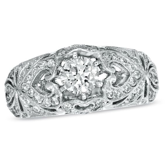 an antique style diamond ring with filigrees