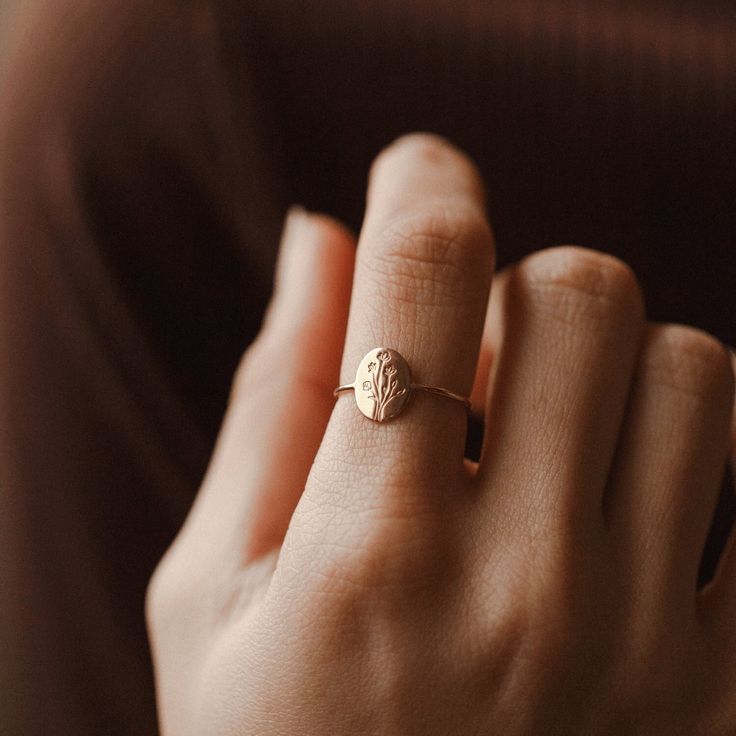 "Symbolizing individuality, authenticity and personal growth, these non-conforming flowers grow wildly without human intervention. Give this floral ring as a gift for you or someone you love--this piece will never lose its bloom!  Every piece is handcrafted and hand-personalized with love in La Conner, WA, using 90% recycled and 100% ethically sourced raw materials from the USA--because it's better that way. Includes free gift-ready packaging (featuring a care card and traditional letterpress goodies made by my dad)!  MATERIALS: * Gold = 14k gold filled * Silver = sterling silver DETAILS: * 10x8mm oval * Original illustrated design * Hand-personalized with traditional metal punches AT CHECKOUT: * If you chose \"other\" for size, specify which ring size you'd like in a note. * Select expedi Dainty Recycled Gold Signet Ring For Wedding, Delicate Promise Rings With Birth Flower, Dainty Oval Initial Ring In 14k Gold, Oval Flower Ring For Wedding, Dainty Oval Recycled Gold Ring, Dainty Oval Yellow Gold Flower Ring, Dainty Oval Ring In Recycled Gold, Gold Oval Flower Ring With Birth Flower Detail, Delicate 14k Gold Birth Flower Rings