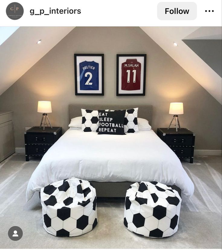 a bed room with a neatly made bed and two soccer themed foot stools on the floor