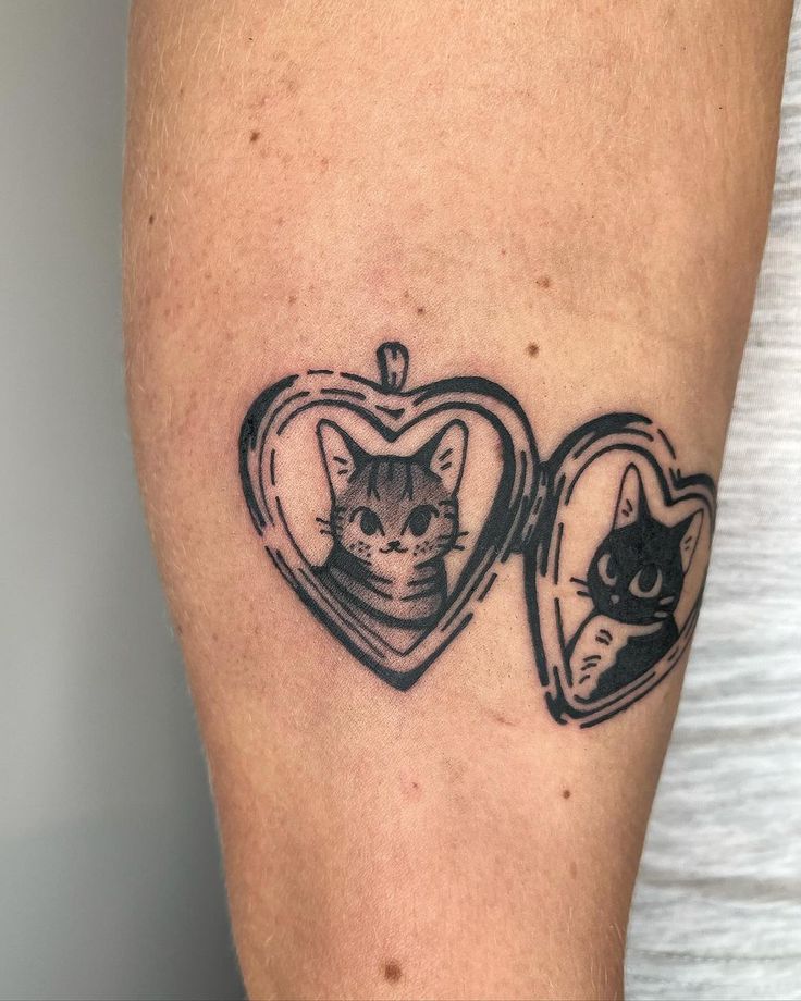 a cat and a heart tattoo on the left thigh, with an image of a cat inside it