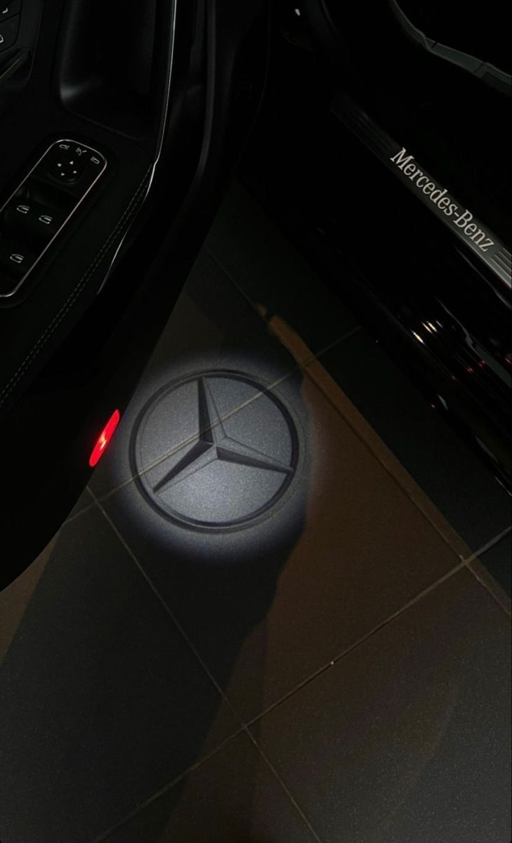 the interior of a mercedes car with its emblem on it's center console and steering wheel