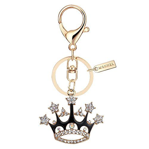 a gold key chain with a crown charm on the front and an embellishment in the middle