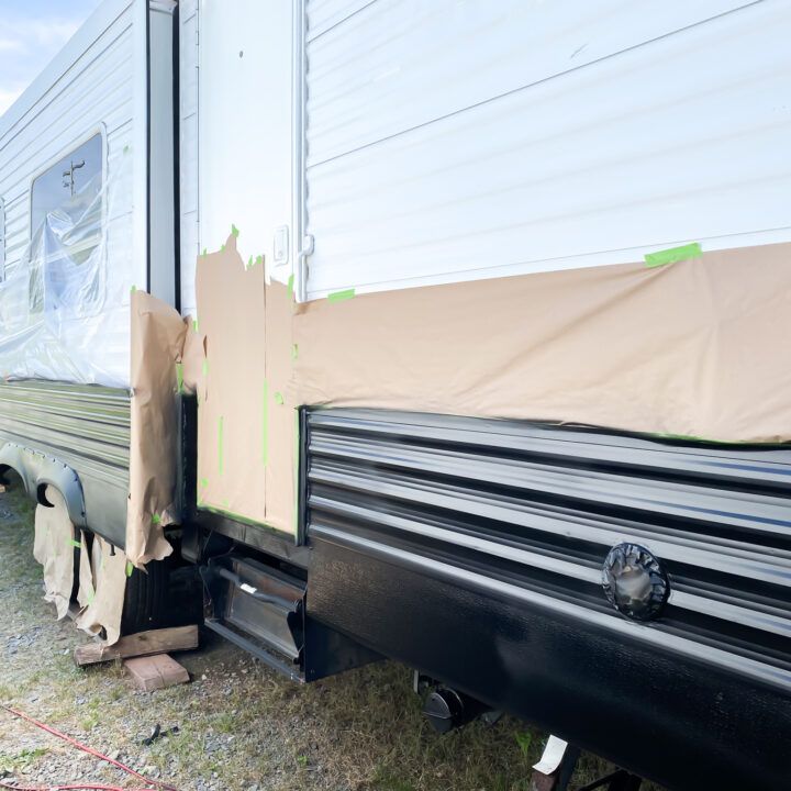 an rv is parked on the grass and covered with a tarp to protect it from sun damage