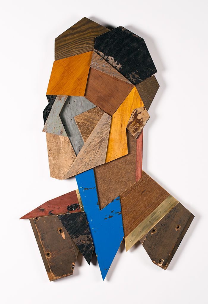 an abstract piece of art made out of wood and various different colored pieces on top of each other