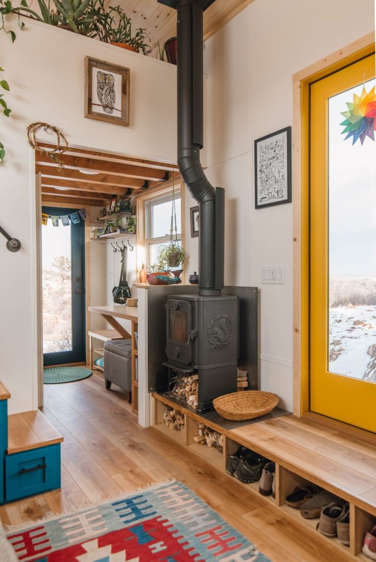 the interior of a tiny home with wood burning stove