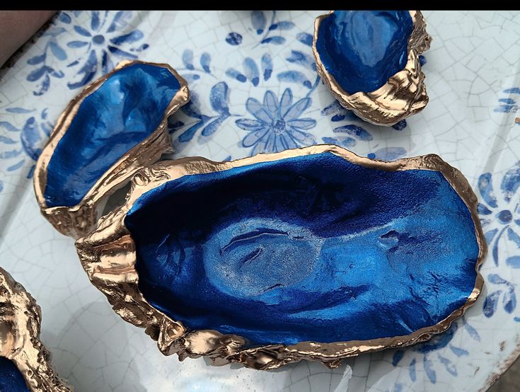 some blue and gold dishes on a table