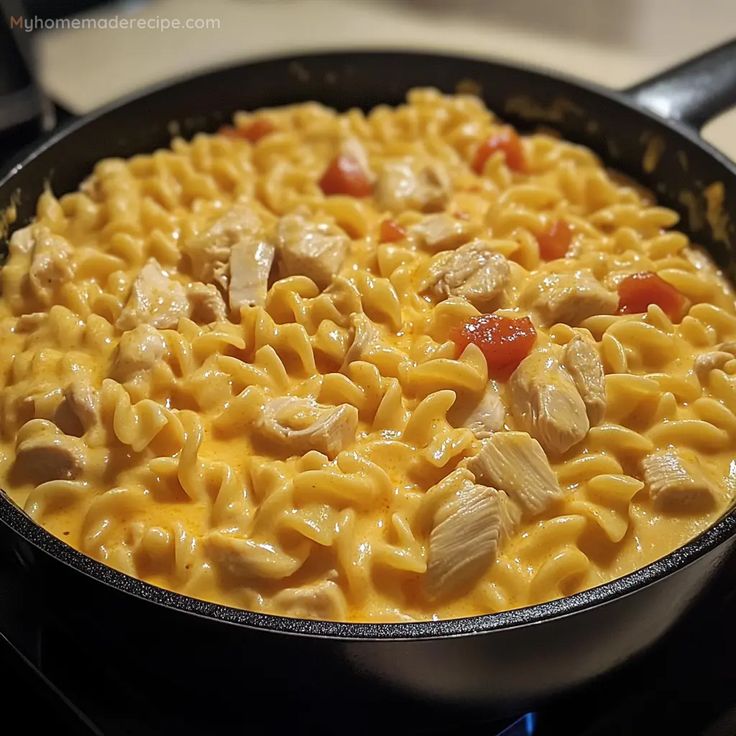 macaroni and cheese with chicken in a skillet