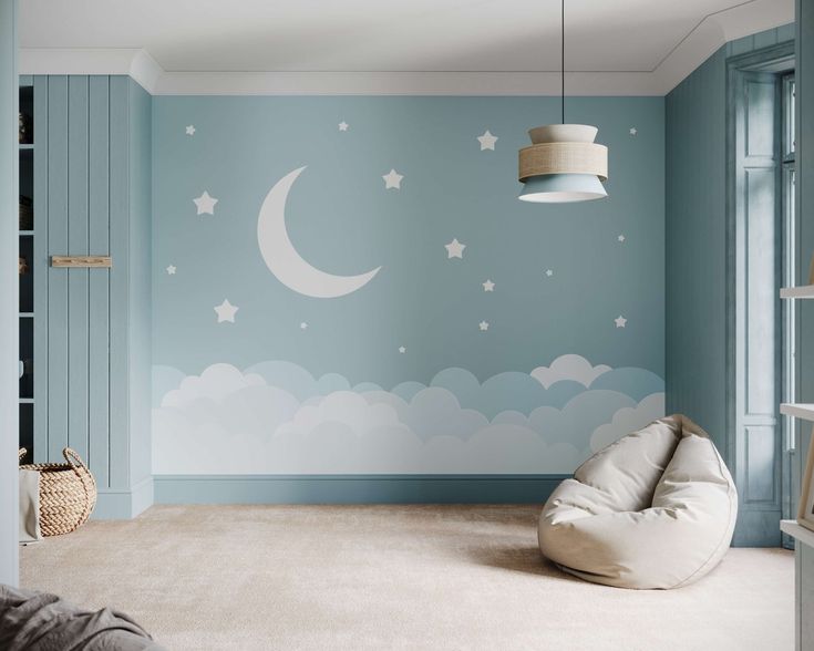 a child's room painted in blue with stars and moon decals on the wall