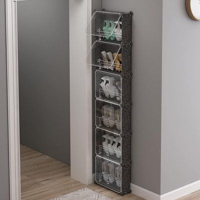 an over door shoe rack holds shoes and other items in the corner of a hallway