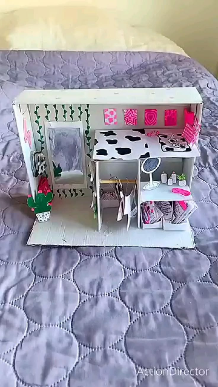 a doll house is on top of a bed