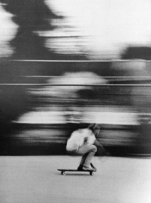 a man riding a skateboard down a street