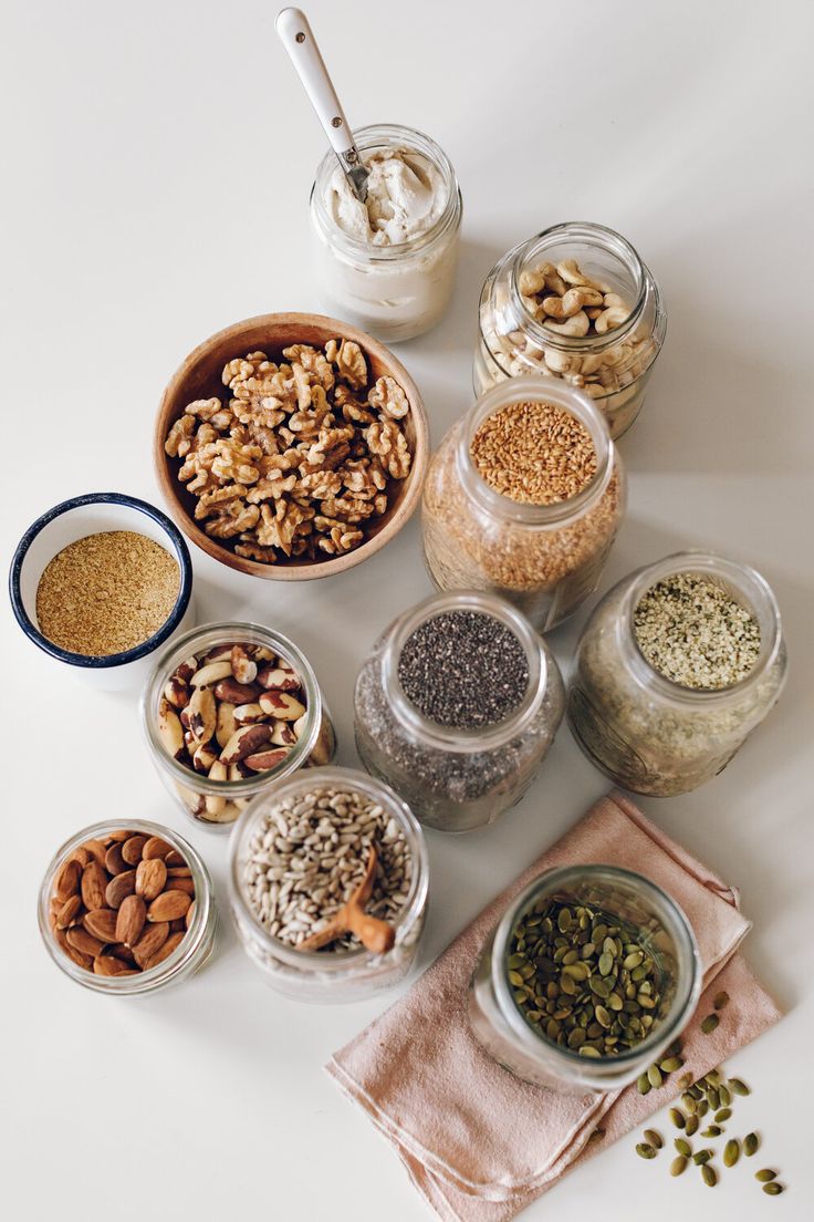 several jars filled with different types of nuts