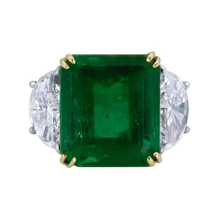 Features a color-rich emerald cut green emerald flanked by two brilliant half-moon diamonds. Set in a delicate and thin 18k yellow gold and platinum mounting. Green Emerald weighs 11.57 carats and is of Colombian origin. Size 6 US. Dimensions: 1.39 cm (L) x 2.15cm (W) Emerald Statement Ring, Colombian Emerald Ring, Triangle Diamond, Platinum Diamond Rings, Emerald Diamond Ring, Bracelet Love, Colombian Emeralds, Diamond Cocktail Rings, Green Jewelry