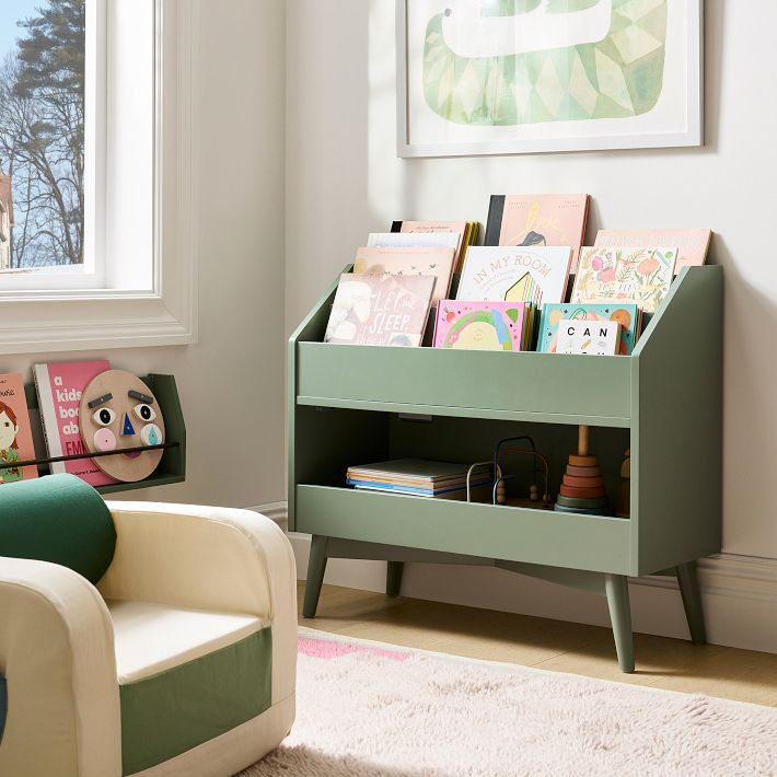 a child's bookshelf in the corner of a living room