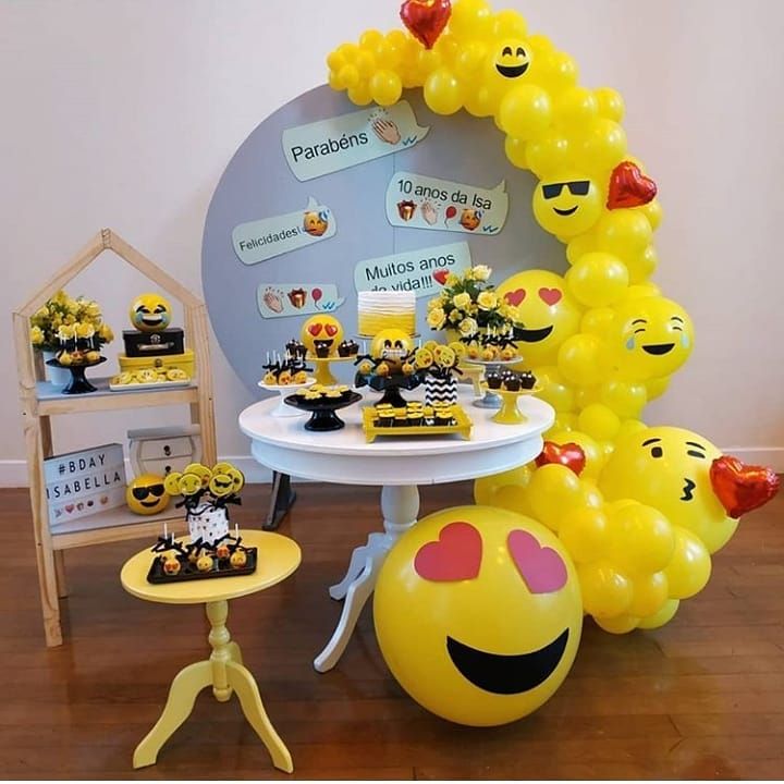 a table topped with lots of yellow balloons