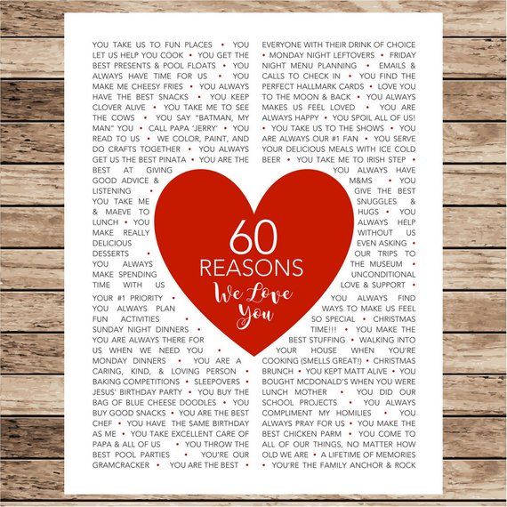 a red heart with the words 60 reasons we love you on it, sitting on top of a wooden table