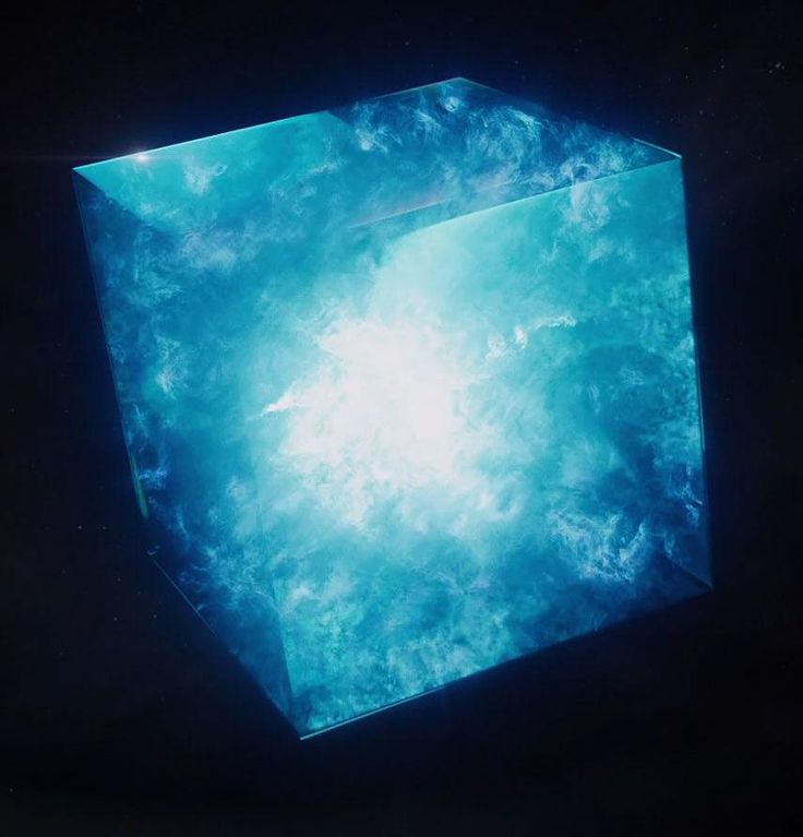 a cube shaped object in the dark with blue and white clouds on it's surface