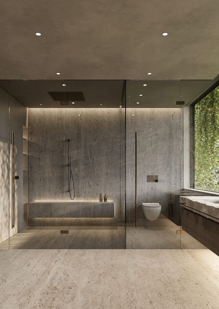 a bathroom with a large glass shower door