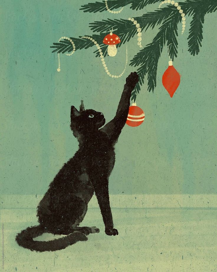 a black cat reaching up at a christmas tree with ornaments hanging from it's branches