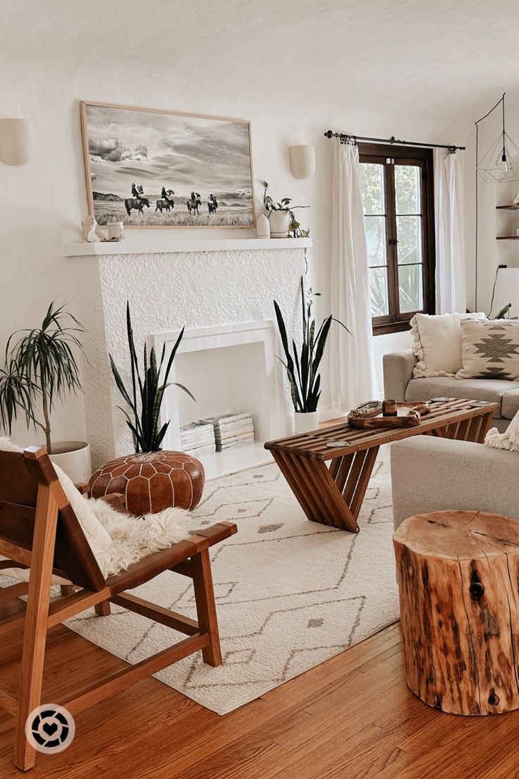 a living room filled with furniture and a fire place next to a wooden table on top of a hard wood floor