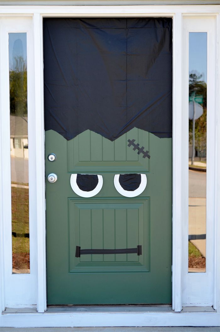 a green door decorated to look like a monster