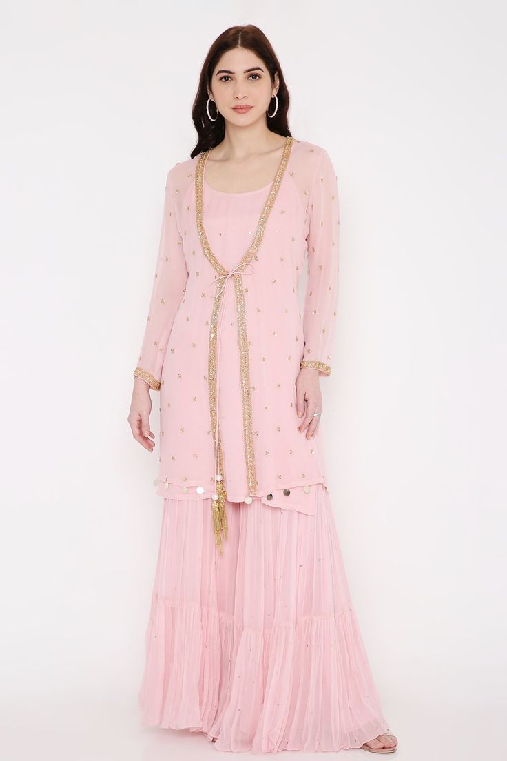 Rosy pink jacket with cut beads, sequin embroidered placket. Paired with short kurta, sharara and dupatta.
Components: 4
Pattern: Embroidery
Type Of Work: Bead, sequin
Neckline: Jacket: Open, Kurta: Round
Sleeve Type: Full sleeves
Fabric: Jacket, Kurta and Sharara: Georgette, Dupatta: Net, Lining: Shantoon
Color: Pink
Other Details: 
Sequin embroidered hem
Front tassel tie-up
Sheer dupatta
Occasion: Destination Wedding - Aza Fashions Pink Long Sleeve Georgette Traditional Wear, Pink Long Sleeve Georgette Salwar Kameez, Embellished Pink Georgette Palazzo Set, Celebration Anarkali Set With Mirror Work And Long Sleeves, Long Sleeve Choli With Dupatta For Celebration, Pink Long Sleeve Traditional Wear For Reception, Long Sleeve Pink Palazzo Set For Wedding, Pink Long Sleeve Festive Set, Festive Pink Long Sleeve Sets