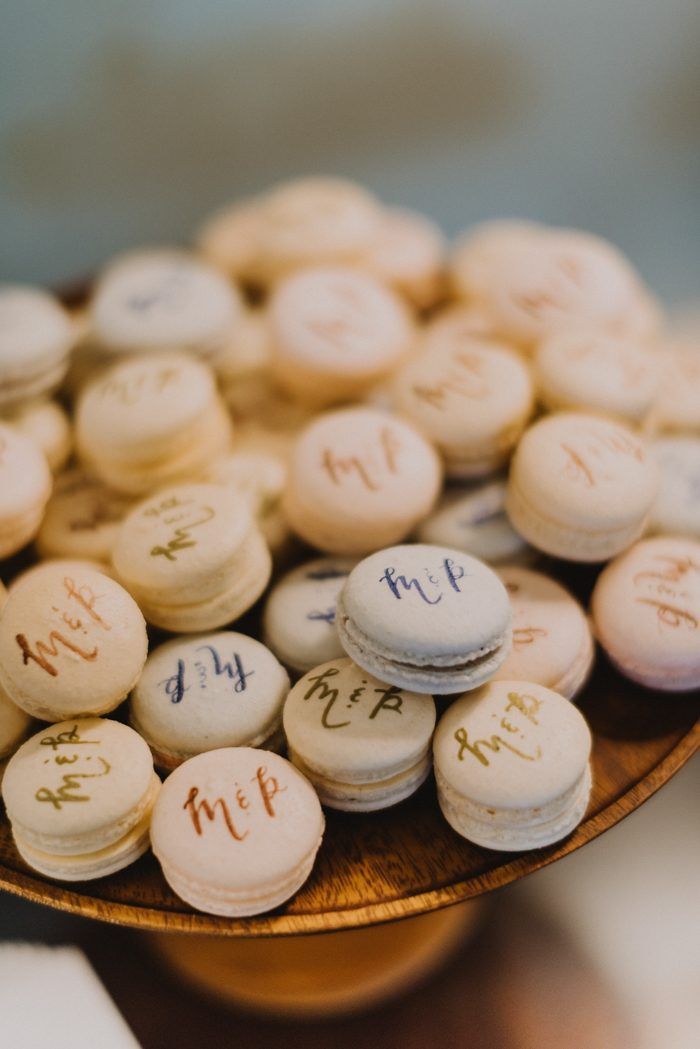 a wooden plate filled with lots of white and brown macaroons