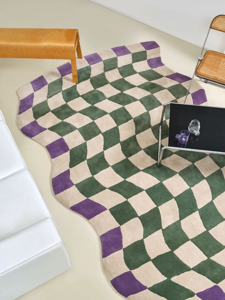 a chair sitting on top of a green and white rug