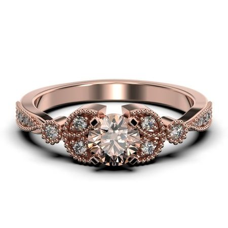 a rose gold engagement ring with diamonds on the sides and an intricate band around it