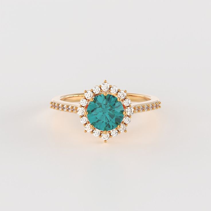 a gold ring with a green stone surrounded by diamonds