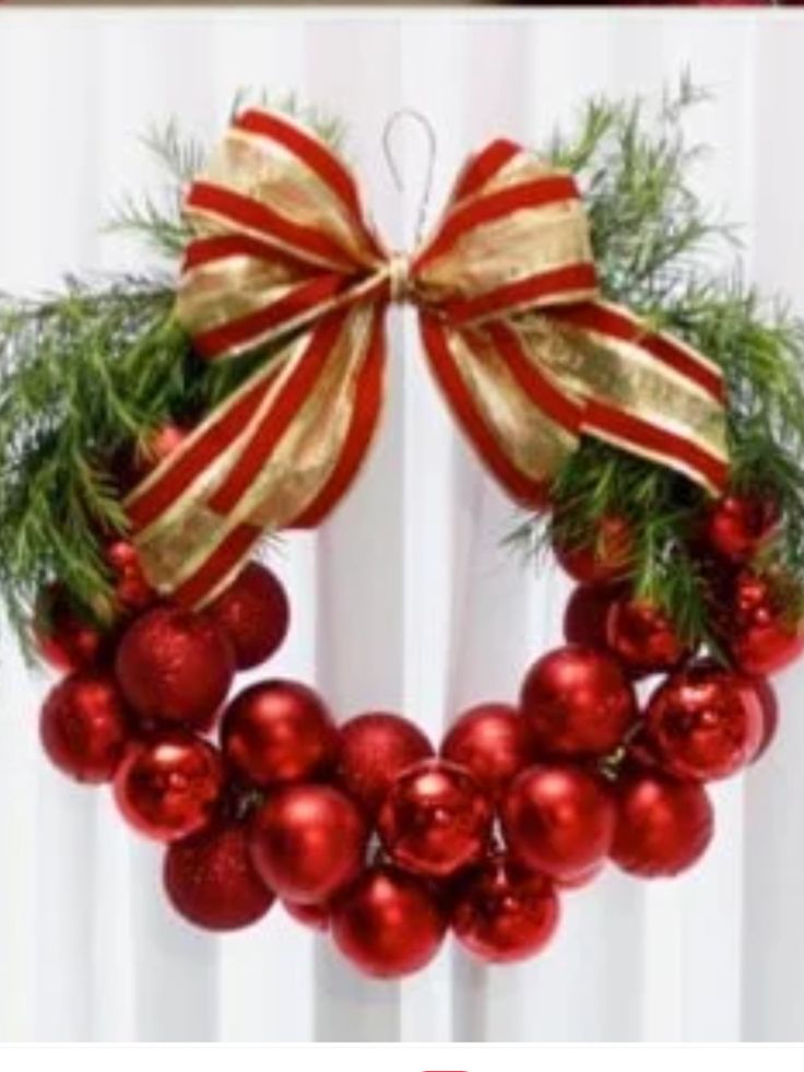 a christmas wreath with red and gold ornaments