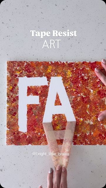 someone using tape to cut out letters on a piece of paper with the word fa