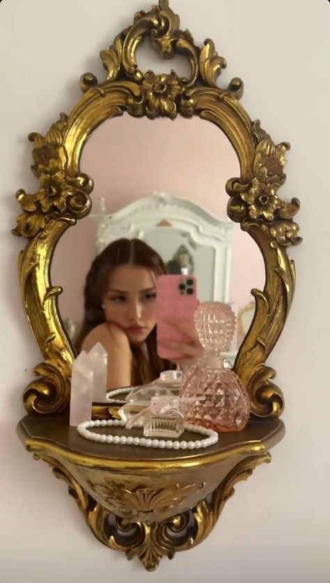 a woman taking a selfie in front of a mirror with other items on it