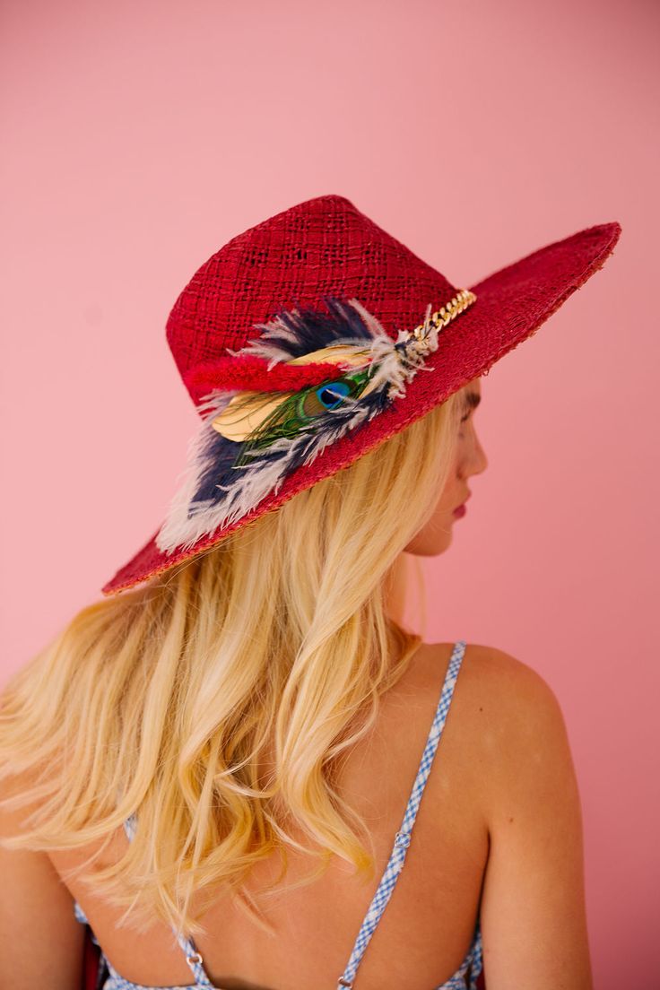 Rock the beach with THE ANGUILLA SUN HAT! This red hat features a stylish gold chain band and a unique combo of white, green, navy and gold feathers. Be the envy of all with this playful and stylish accessory. (Sunburn not included!) This hat is ONE OF A KIND, created by our owner Stephanie. To receive item quicker, expedited shipping is available at checkout. Beach Hats With Feathers And Wide Brim, Summer Fedora Hat, Bohemian Summer Hats With Feathers, Bohemian Red Hats For Kentucky Derby, Bohemian Red Hat For Kentucky Derby, Wide Brim Summer Hat, Red Bohemian Sun Hat For Vacation, Red Bohemian Straw Hat With Short Brim, Wide Brim Beach Hat With Feathers