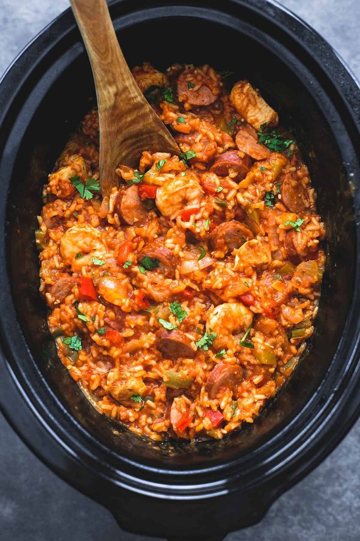 a slow cooker filled with rice and meat