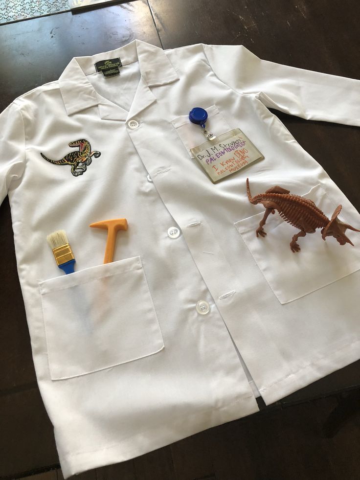 a white lab coat with dinosaur magnets on it