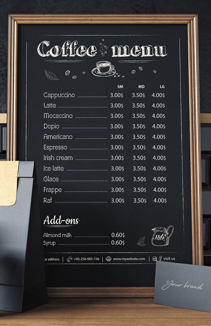 a coffee menu on a blackboard next to a cup of coffee