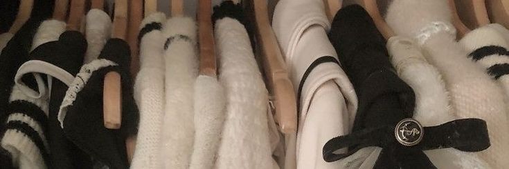 several pairs of tennis shoes are lined up in a rack with black and white furs on them