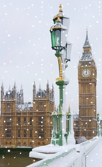 the big ben clock tower towering over the city of london covered in snow and ice