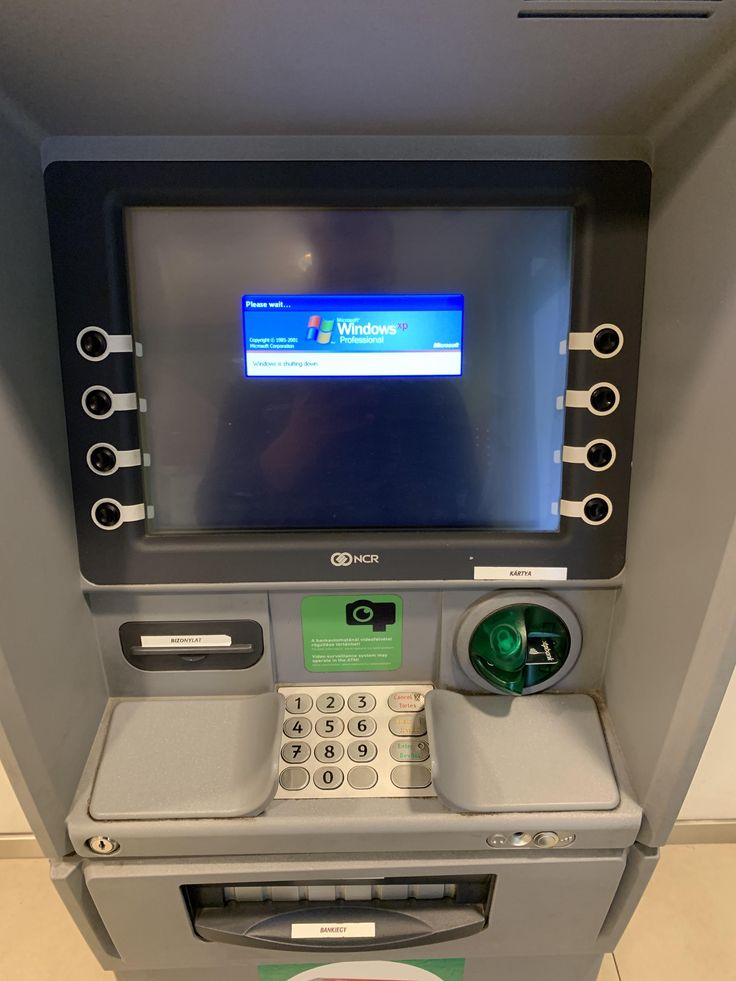 an atm machine with a screen on the front, and buttons on the back side