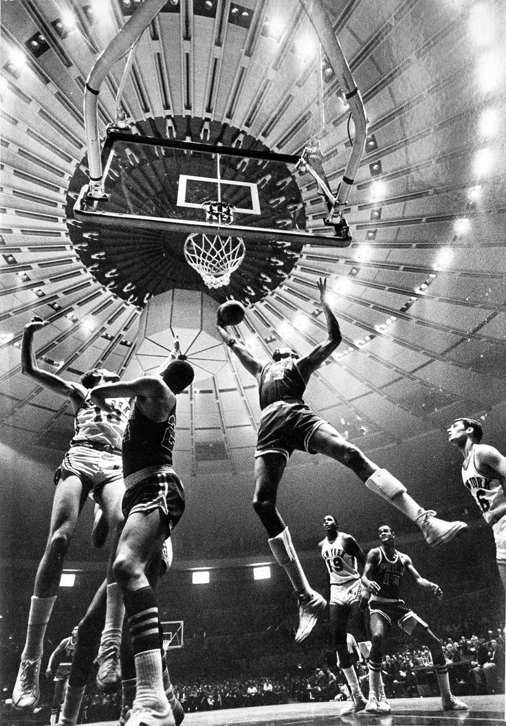 a group of men playing basketball in an arena