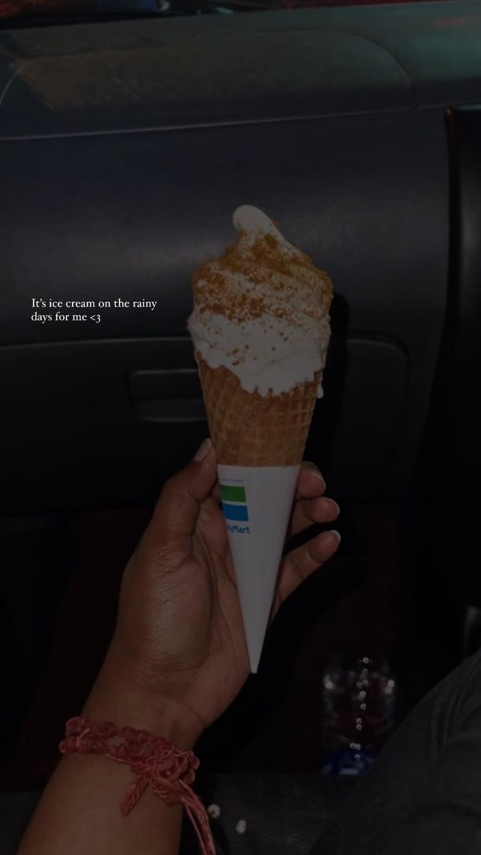 a person is holding an ice cream cone in their hand