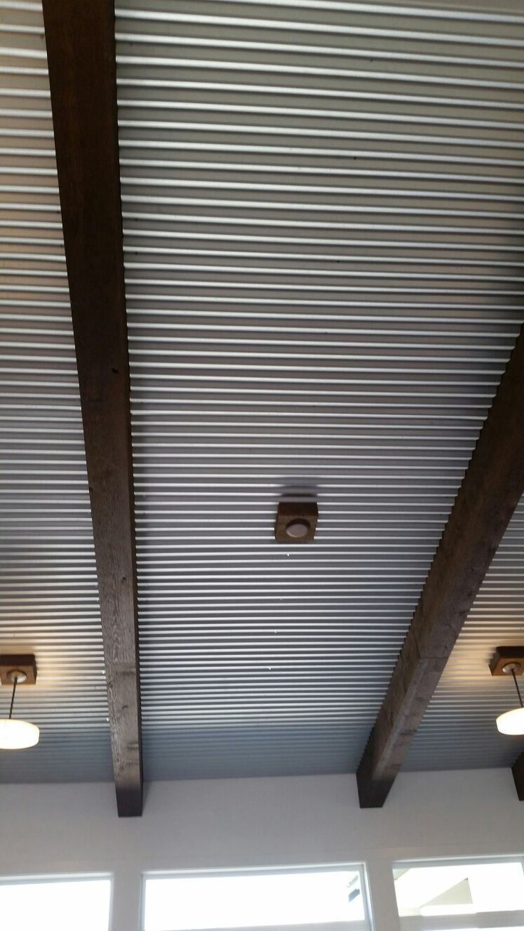 the ceiling in this room is made from corrugated and has three lights on each side